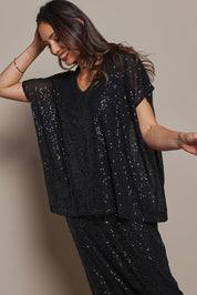 Model Amanda wearing size 10 of the Renee Sequin Top in colour Black (Metallics), from the front, cropped image