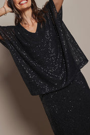 Model Amanda wearing size 10 of the Renee Sequin Top in colour Black (Metallics), from the front, cropped image