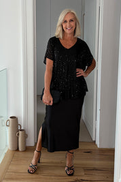 Model Sandy wearing size 10 of the Renee Sequin Top in colour Black (Metallics), from the front, showing the whole outfit