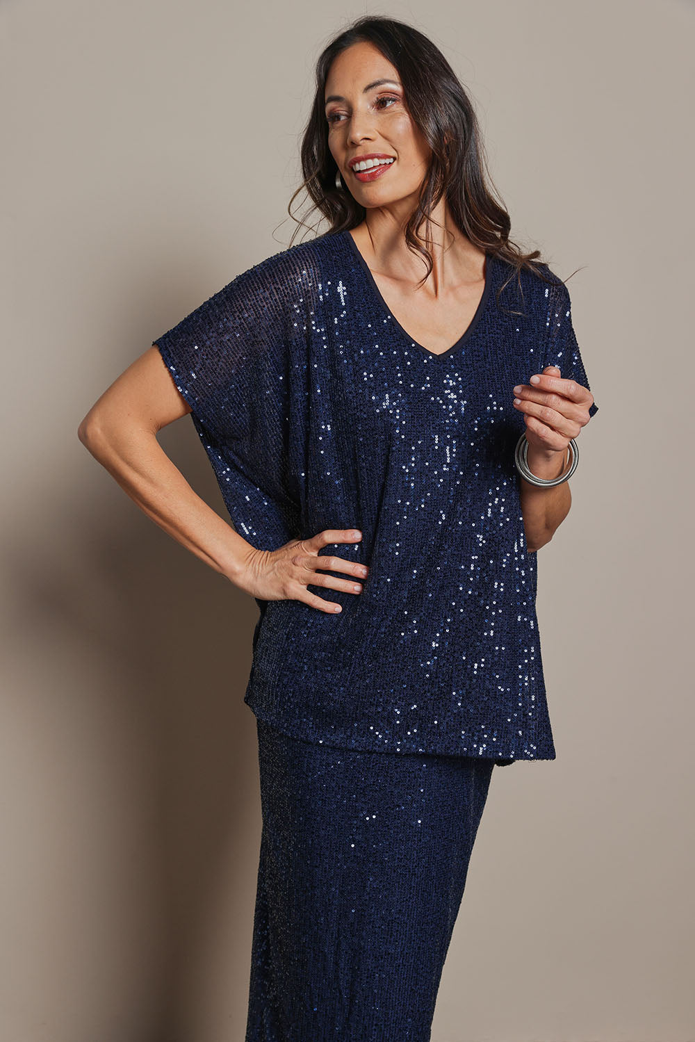 Model Amanda wearing size 10 of the Renee Sequin Top in colour Navy (Metallics), from the front, cropped image