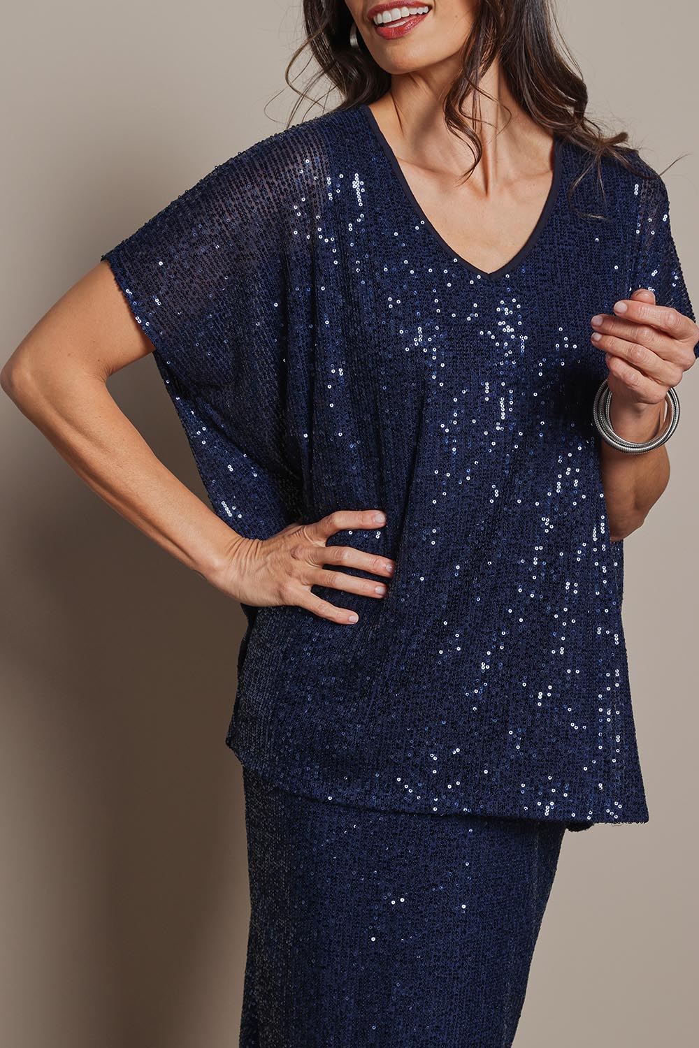 Model Amanda wearing size 10 of the Renee Sequin Top in colour Navy (Metallics), from the front, cropped image