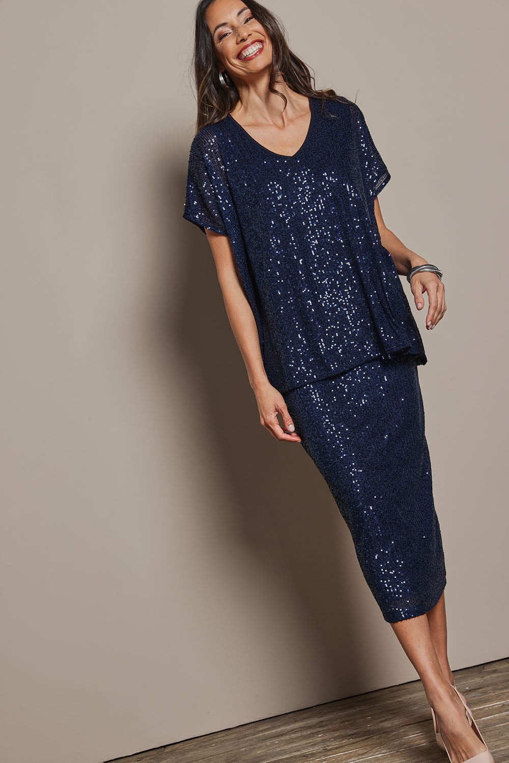 Model Amanda wearing the Renee Sequin Top in colour Navy (Metallics), from the front, showing the whole outfit