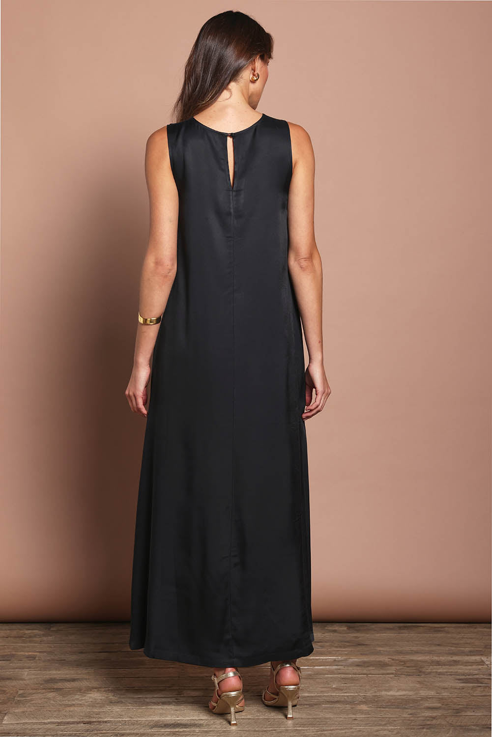 Model Madeline wearing size 10 of the Linda Dress in colour Black (Black), from the back