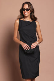 Model Madeline wearing size 10 of the Audrey Dress in colour Black (Black), from the front, cropped image