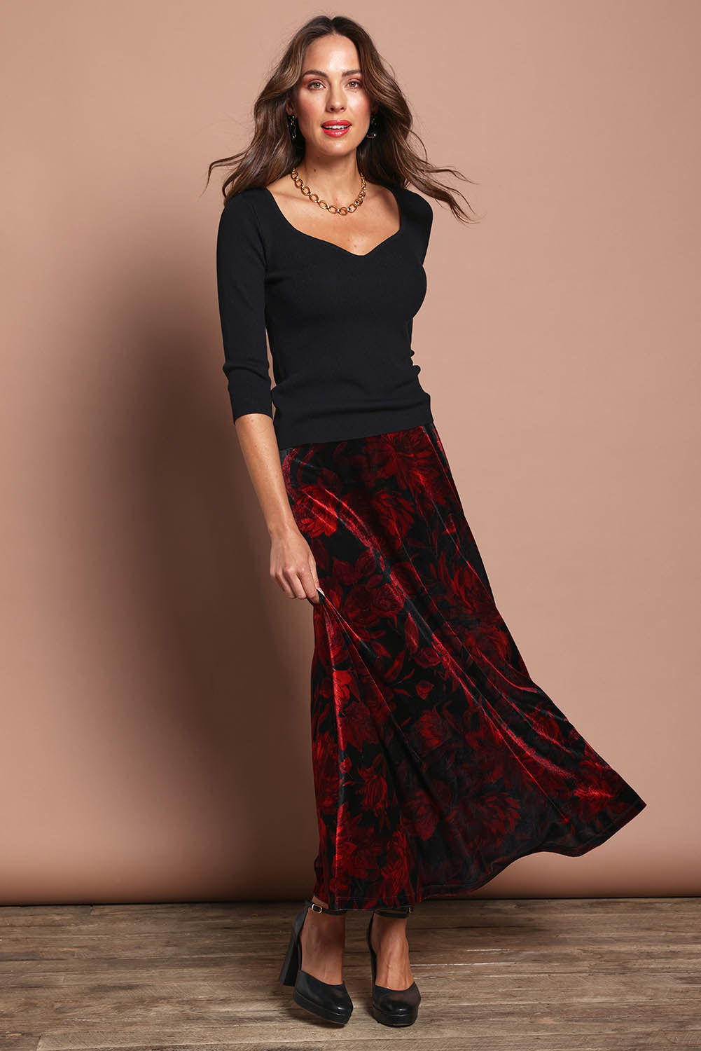 Model Madeline wearing size 10 of the Sabrina Velour Skirt in colour Nightfleur (Red), from the front, showing the whole outfit