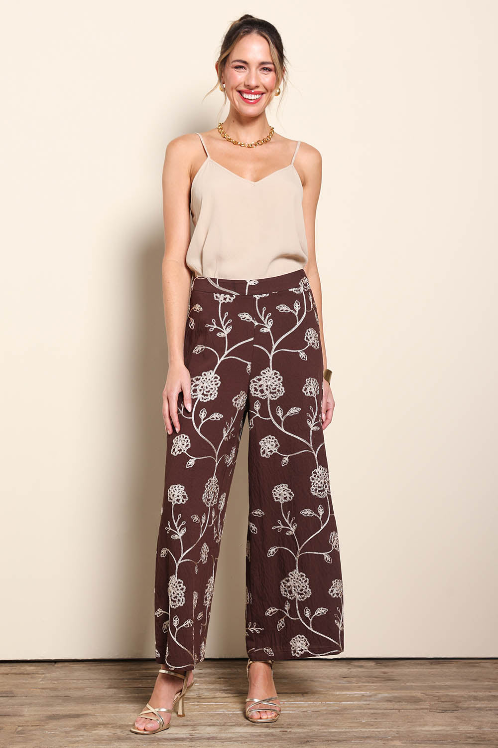 Model Maddiec wearing size 10 of the Celia Pants - Chocolategold in colour Chocolategold, from the front