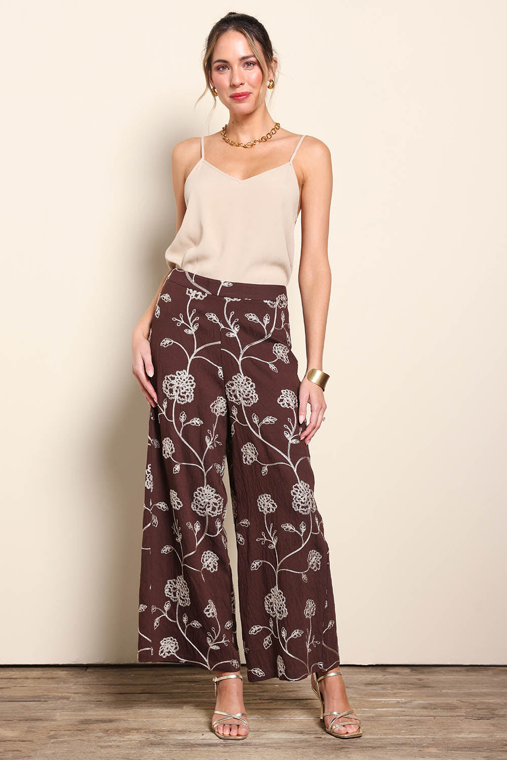 Model Maddiec wearing size 10 of the Celia Pants - Chocolategold in colour Chocolategold, from the front