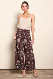 Model Maddiec wearing size 10 of the Celia Pants - Chocolategold in colour Chocolategold, from the front