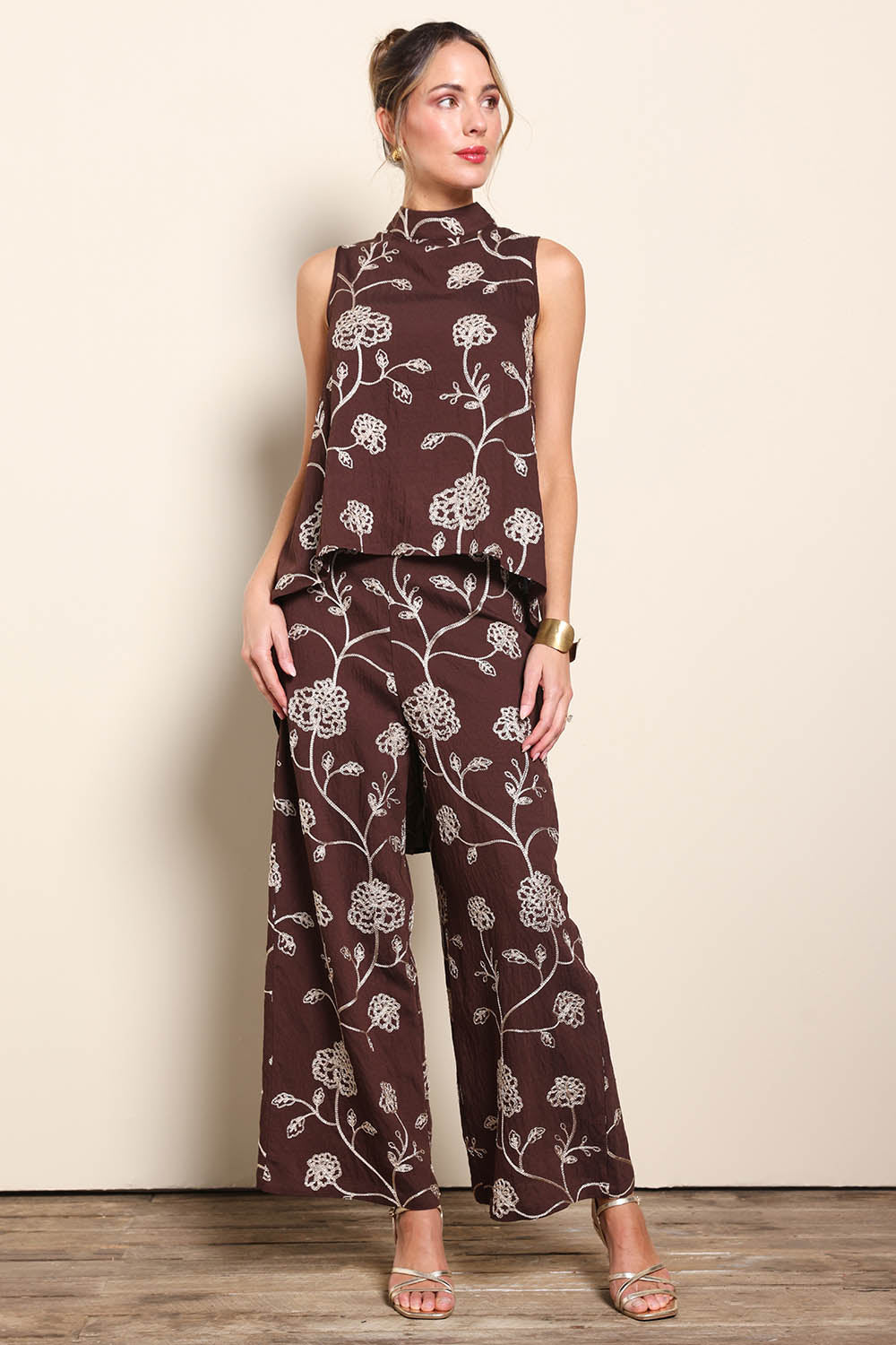 Model Maddiec wearing size 10 of the Celia Pants - Chocolategold in colour Chocolategold, from the front