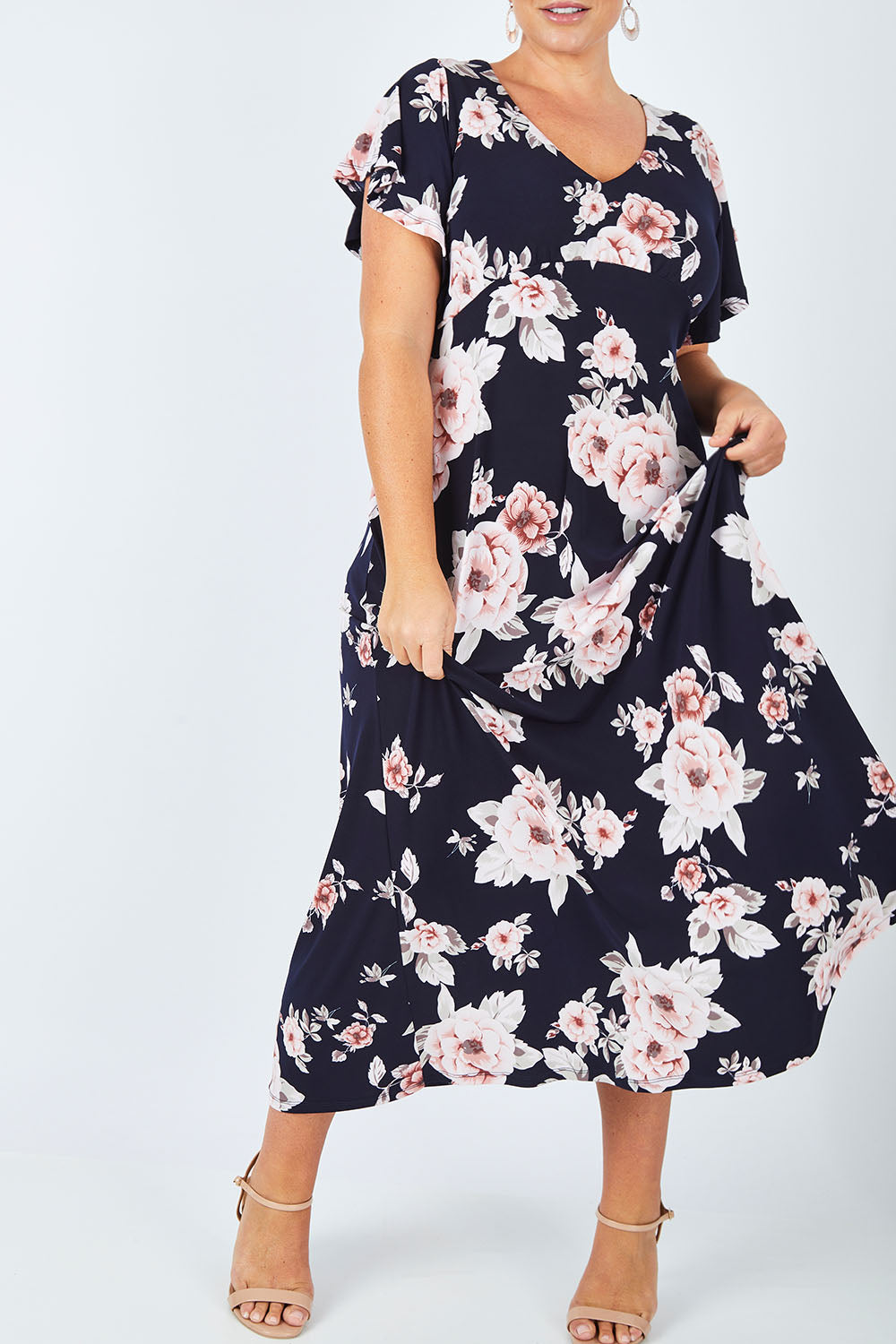 Model Fiona wearing size 16 of the Lucille Dress in colour NavyFloral (Blue), from the front, cropped image