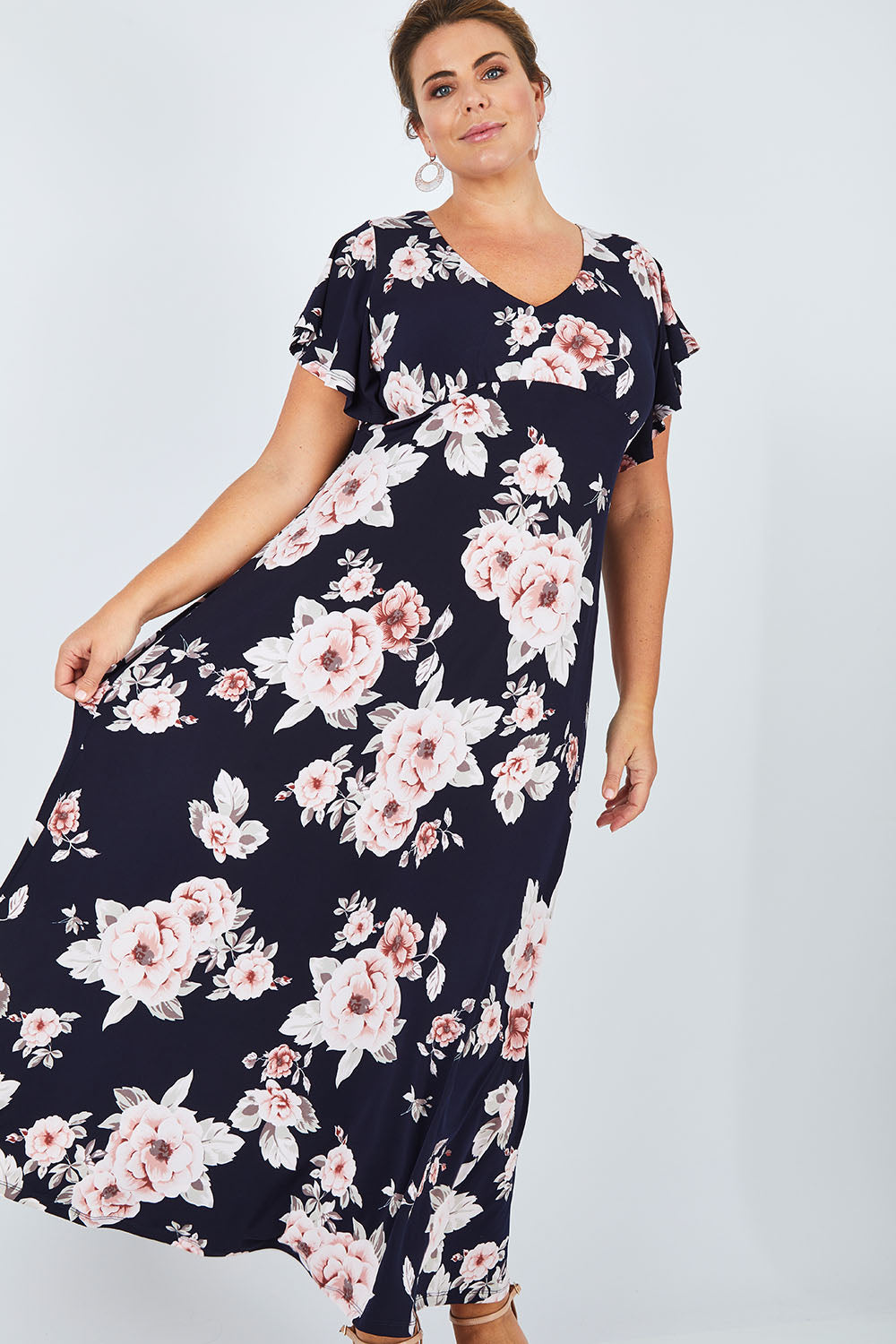 Model Fiona wearing size 16 of the Lucille Dress in colour NavyFloral (Blue), from the front, showing the whole outfit