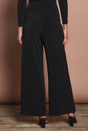 Model Madeline wearing size 10 of the Kristi Pants in colour Black (Black), from the back