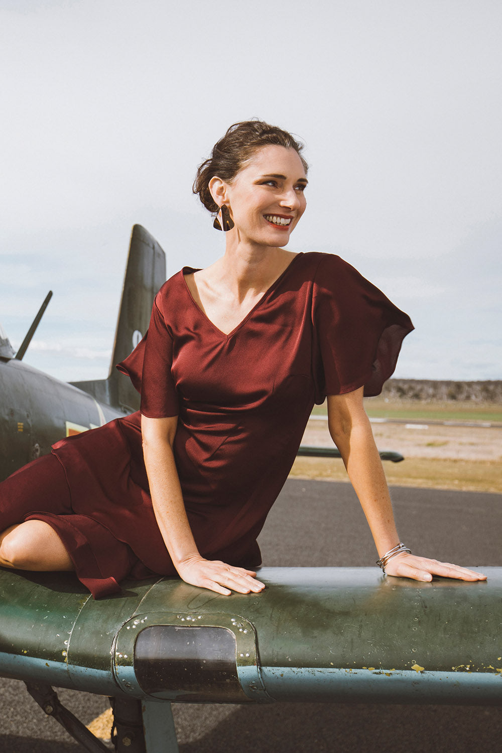 Model Anneliese wearing size 10 of the Kimberley Dress in colour Wine (Red), from the front, showing the whole outfit