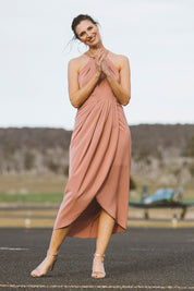 Model Anneliese wearing size 10 of the Adriana Dress in colour Camelia (Pink), from the front, showing the whole outfit