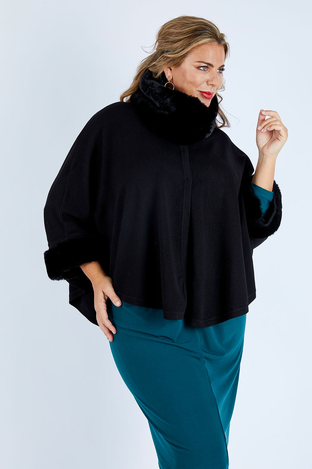 Model Fiona wearing size OneSize of the Brigitte Cape in colour Black (Black), from the front, cropped image