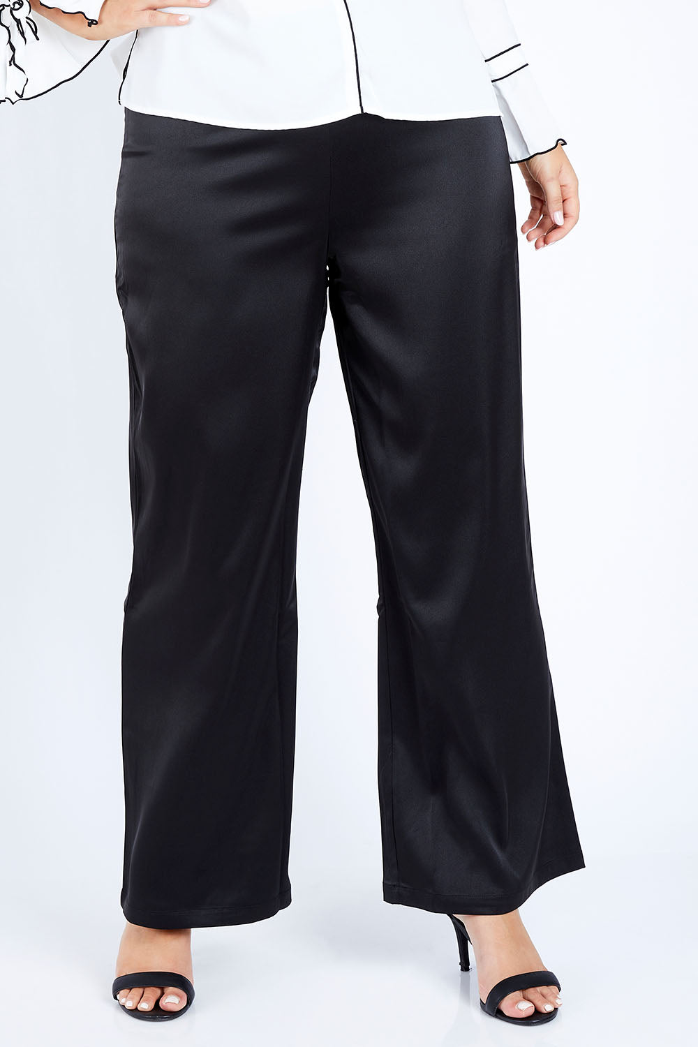 Model Jess wearing size 14 of the Tina Pants in colour Black (Black), from the front, cropped image