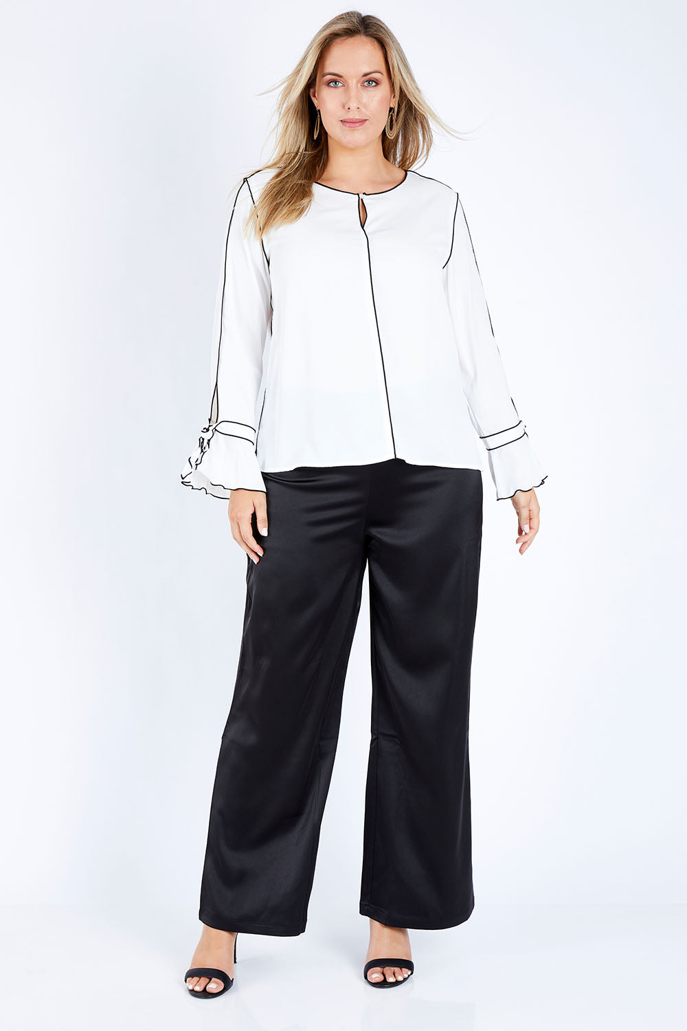 Model Jess wearing size 14 of the Tina Pants in colour Black (Black), from the front, showing the whole outfit