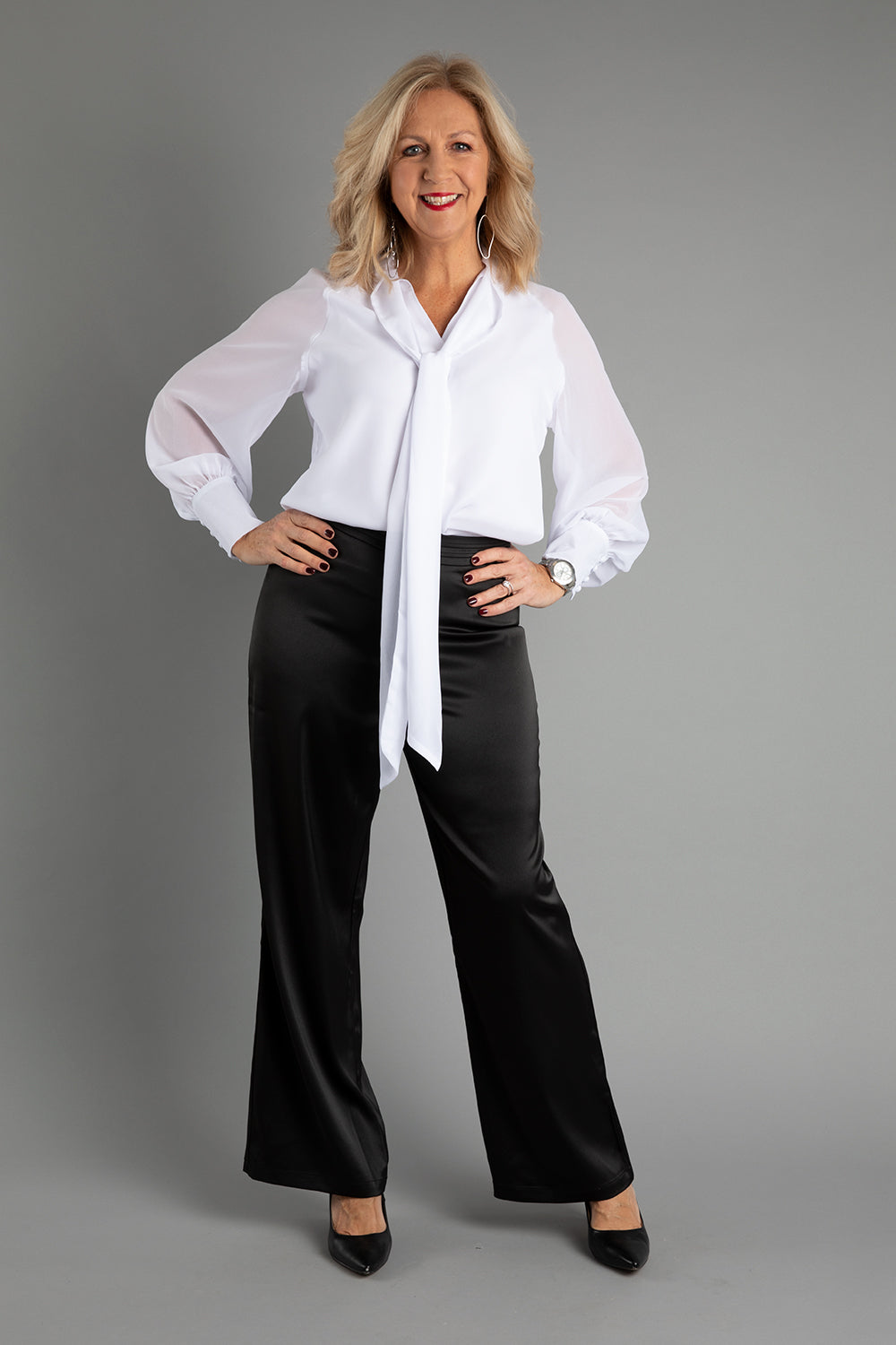 Model Sandy wearing size 10 of the Elena Blouse in colour Snow (White), from the front, showing the whole outfit