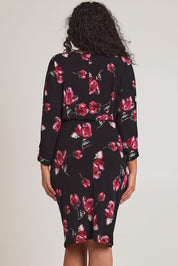 Model Terri-Leigh wearing size 14 of The Printed Nancy Dress in colour Roses (Black), from the back