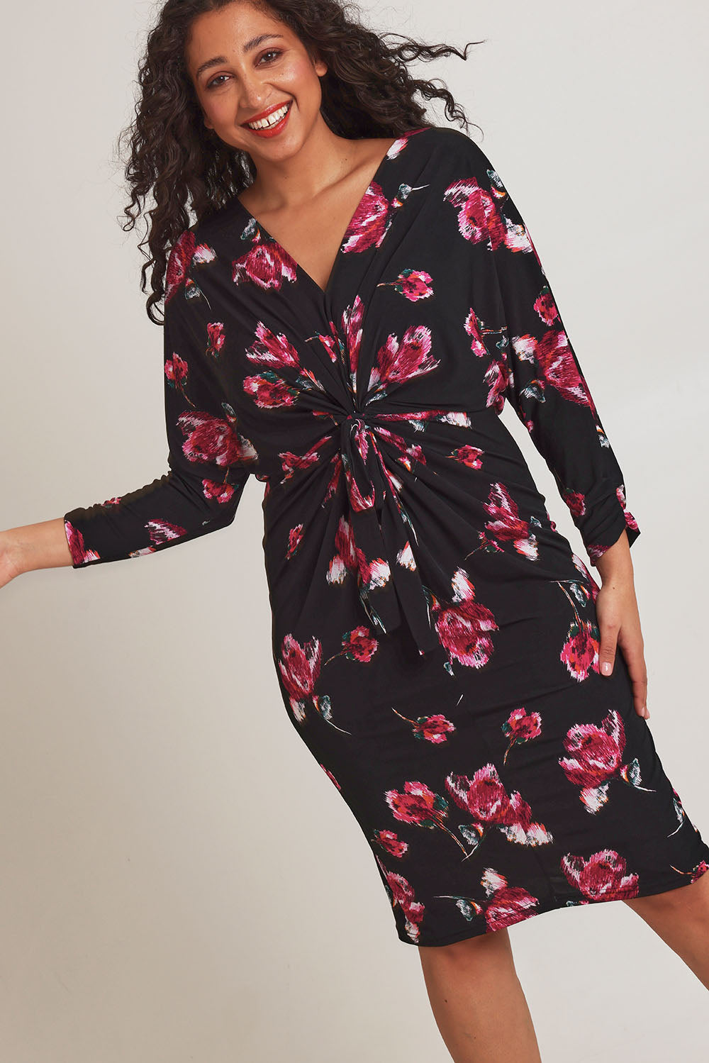 Model Terri-Leigh wearing size 14 of The Printed Nancy Dress in colour Roses (Black), from the front, cropped image