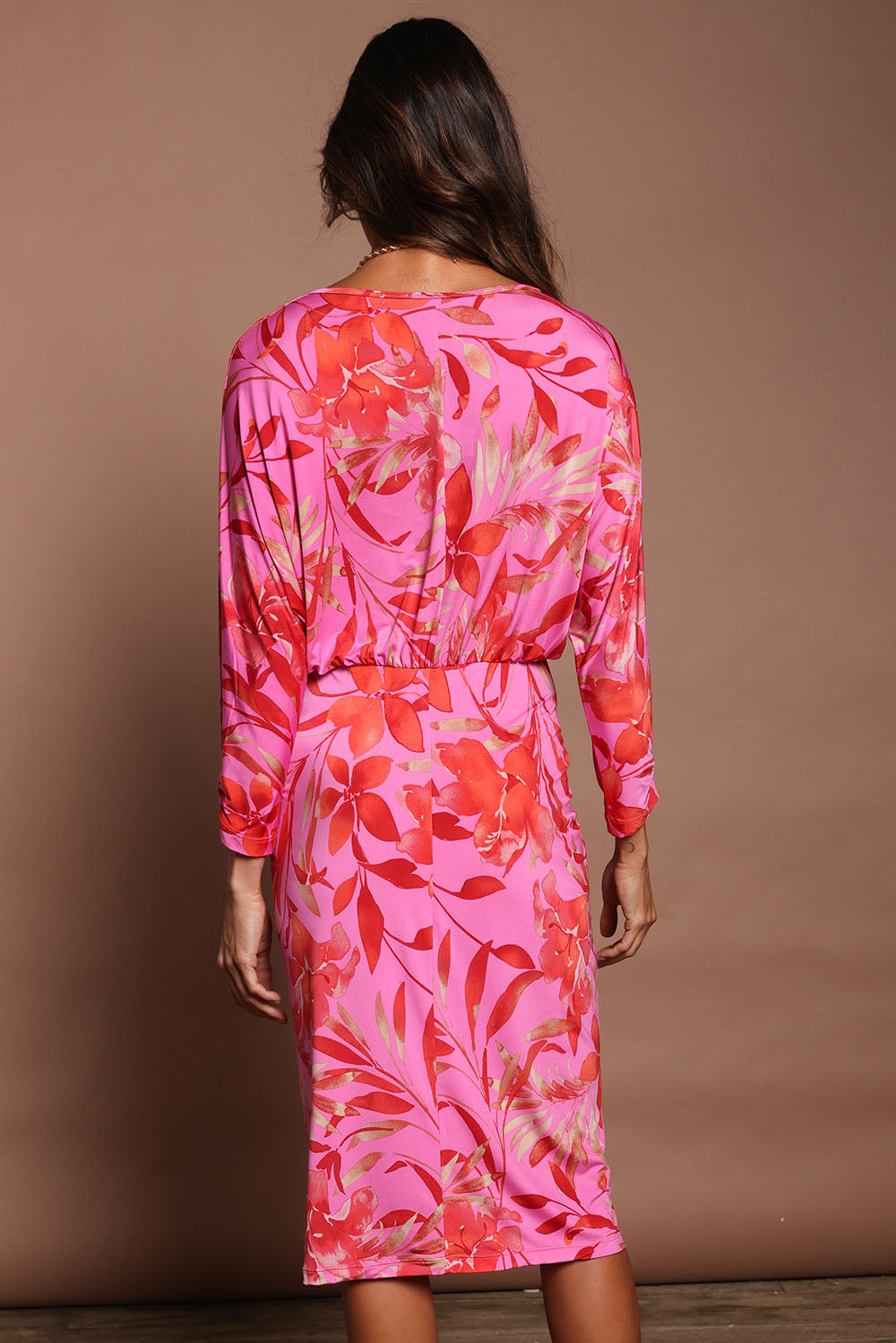 Model Amanda wearing size 10 of The Printed Nancy Dress in colour Pinklily (Pink), from the back