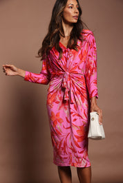 Model Amanda wearing size 10 of The Printed Nancy Dress in colour Pinklily (Pink), from the front, cropped image