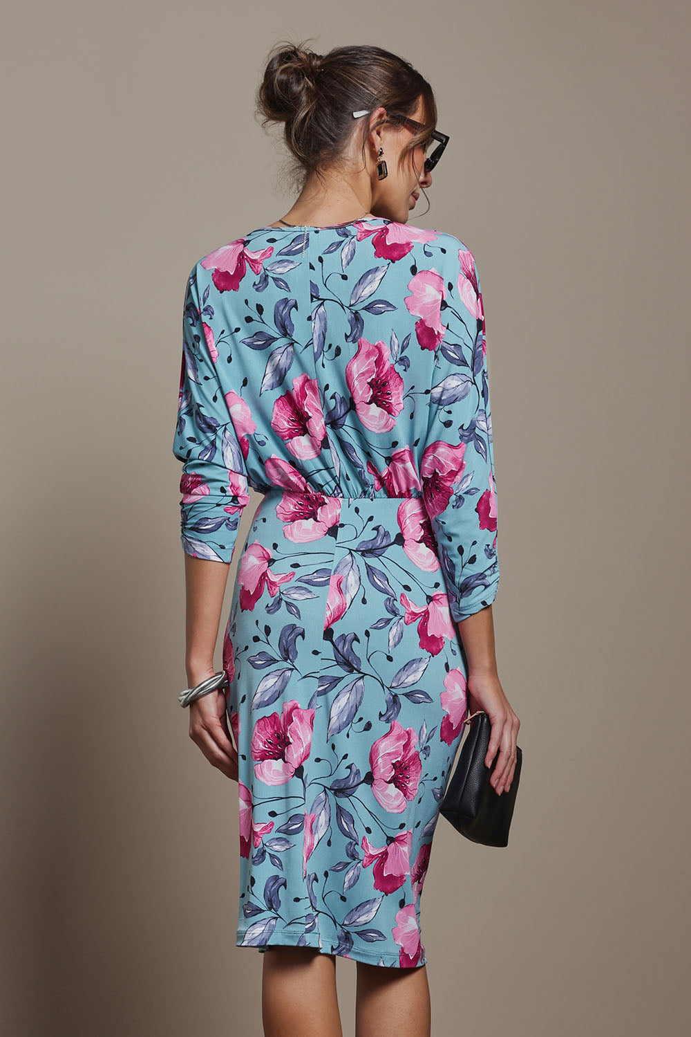 Model Madeline wearing size 10 of The Printed Nancy Dress in colour Windflower, from the back