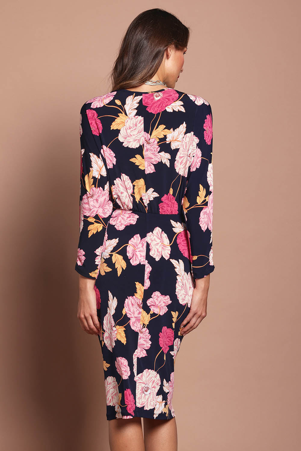 Model Madeline wearing size 10 of The Printed Nancy Dress in colour Poppies (Pink), from the back