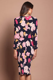 Model Madeline wearing size 10 of The Printed Nancy Dress in colour Poppies (Pink), from the back