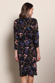 Model Maddiec wearing size 10 of the The Printed Nancy Dress – Floral in colour Floral, from the back