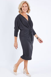 Model Sandy wearing size 10 of the Nancy Dress in colour Graphite (Grey), from the front, showing the whole outfit