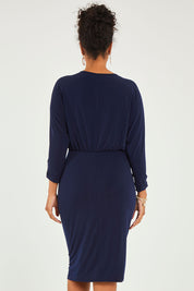 Model Noli wearing size 14 of the Nancy Dress in colour Navy (Blue), from the back