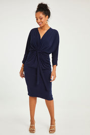 Model Noli wearing size 14 of the Nancy Dress in colour Navy (Blue), from the front, showing the whole outfit