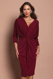 Model Madeline wearing size 10 of the Nancy Dress in colour Port (Red), from the front, cropped image