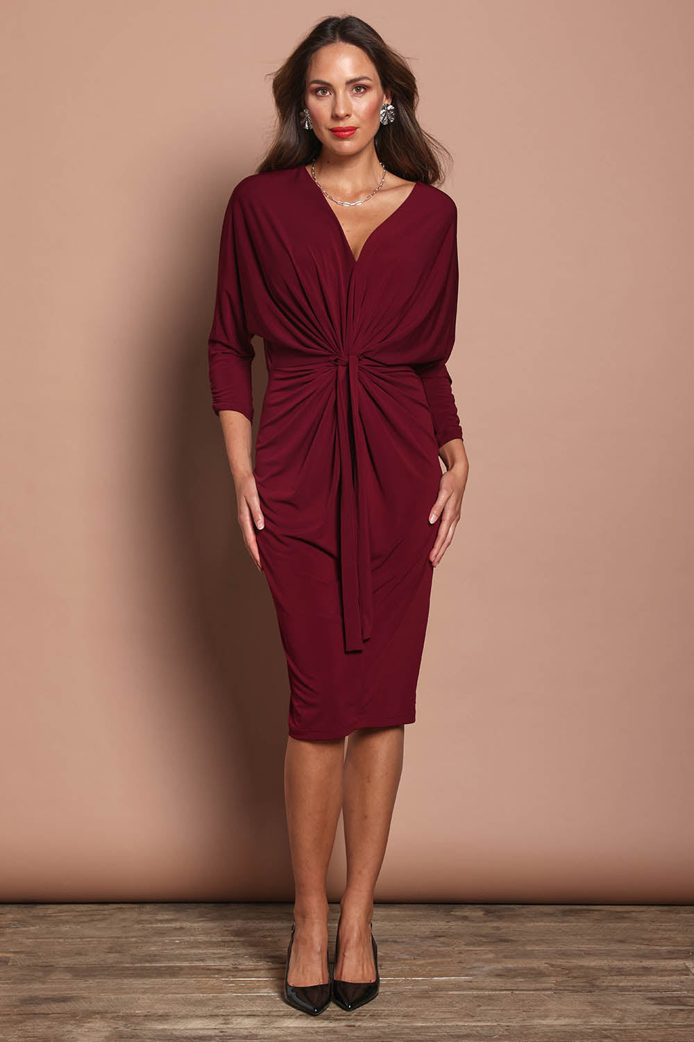 Model Madeline wearing size 10 of the Nancy Dress in colour Port (Red), from the front, showing the whole outfit