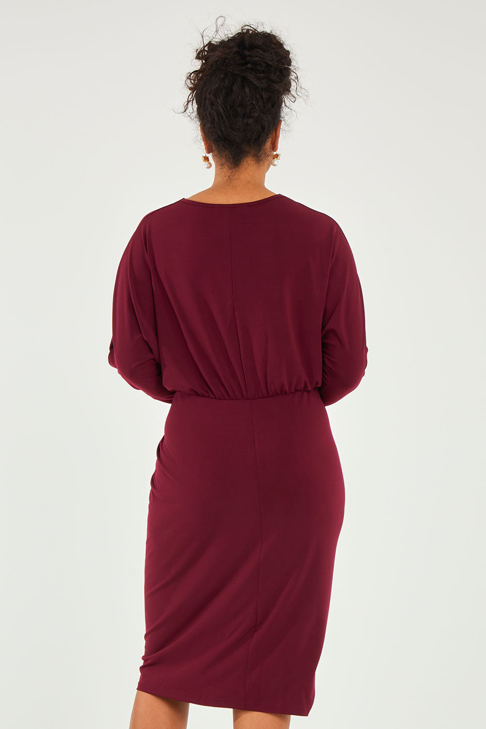 Model Noli wearing size 14 of the Nancy Dress in colour Port (Red), from the back