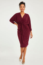Model Noli wearing size 14 of the Nancy Dress in colour Port (Red), from the front, showing the whole outfit