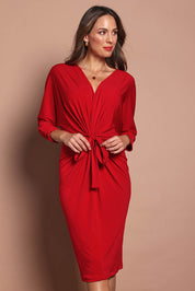 Model Madeline wearing size 10 of the Nancy Dress in colour Red (Red), from the front, cropped image