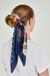 A model wearing size OneSize of the Federica Hair Scarf in colour Navyprint (Blue), from the back
