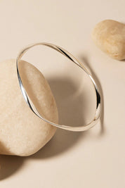 A model wearing the Garden Of Eden Bangle in colour Silver (Metallics), from the front, showing the whole outfit