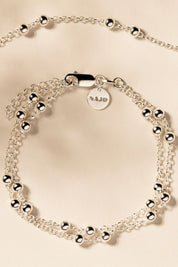 A model wearing the Mattina Silver Bracelet in colour Silver (Metallics), from the front, showing the whole outfit