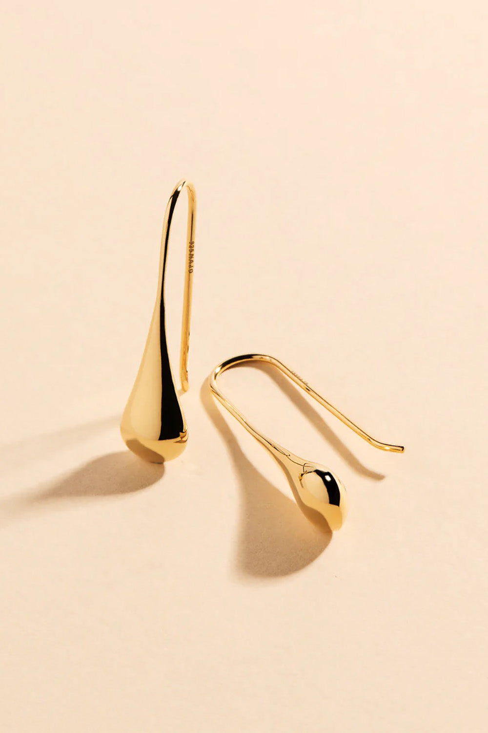 A model wearing the My Silent Tears Earrings in colour Gold (Metallics), from the front, showing the whole outfit