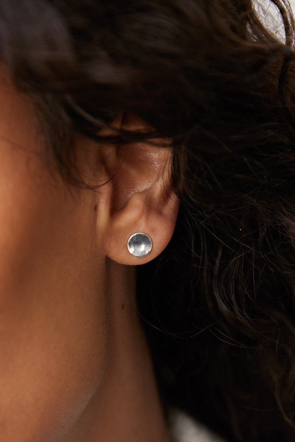 A model wearing the Double Beat Sterling Silver Earrings in colour Silver (Metallics), from the front, showing the whole outfit