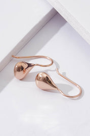A model wearing size OneSize of the Baby Tears Earrings in colour RoseGold (Metallics), from the front, showing the whole outfit