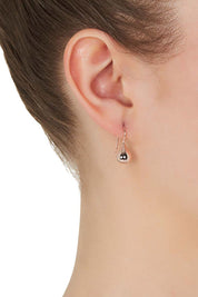 A model wearing the Baby Tears Earrings in colour RoseGold (Metallics), from the front, showing the whole outfit