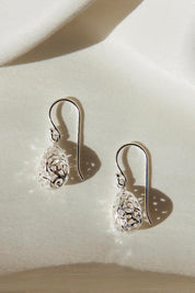 A model wearing the Boobelah Sterling Silver Earrings in colour Silver (Metallics), from the front, showing the whole outfit