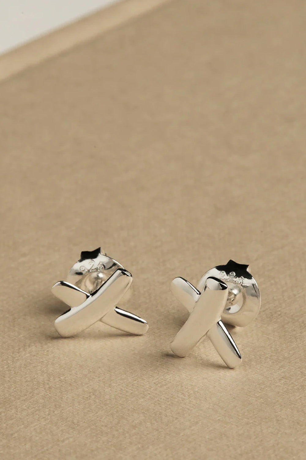 A model wearing the Sterling Silver Kiss Stud Earrings in colour Silver (Metallics), from the front, showing the whole outfit
