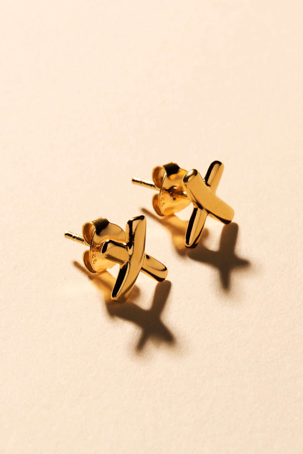 A model wearing the Gold Kiss Stud Earrings in colour Gold (Metallics), from the front, showing the whole outfit