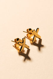 A model wearing the Gold Kiss Stud Earrings in colour Gold (Metallics), from the front, showing the whole outfit
