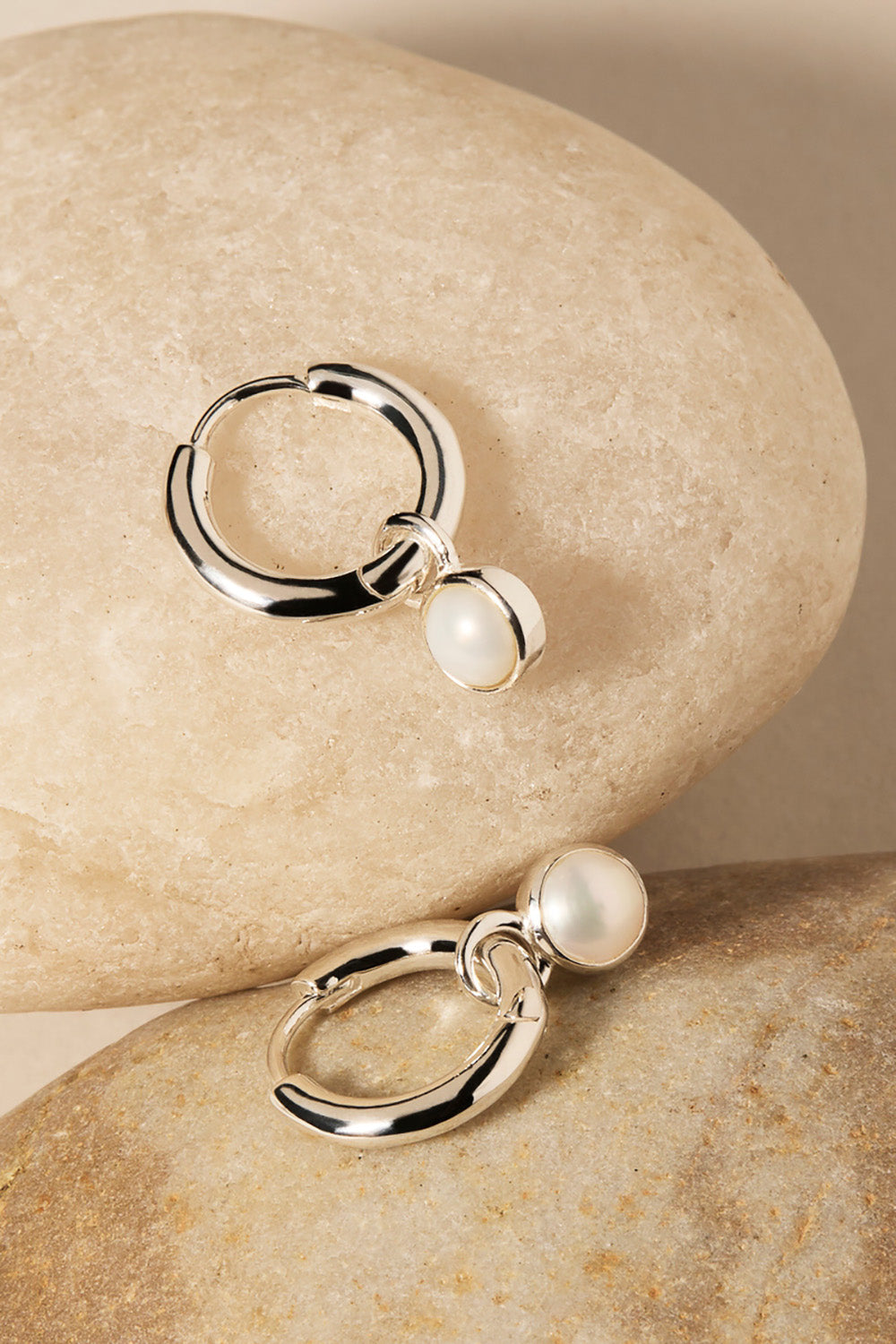 A model wearing the Heavenly Pearl Earrings in colour Silver (Metallics), from the front, showing the whole outfit
